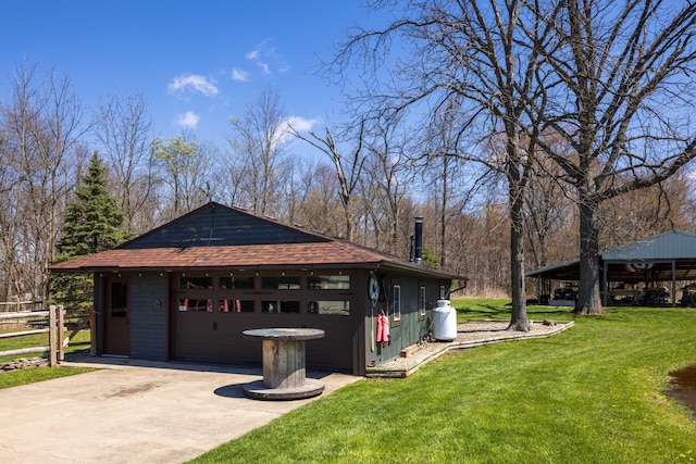 9704 Loudon St, Johnstown, OH 43031 - view of side of home with driveway, fence, a garage, an outdoor structure, and a yard