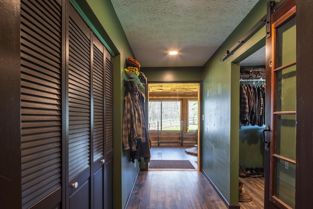 9704 Loudon St, Johnstown, OH 43031 - hall with baseboards, a textured ceiling, and wood-type flooring