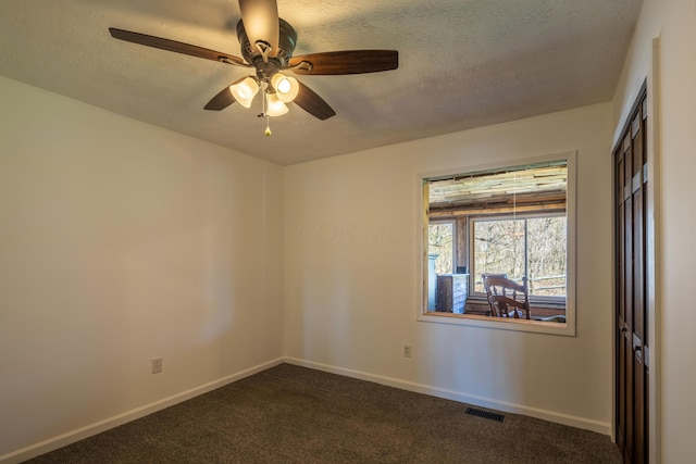 9704 Loudon St, Johnstown, OH 43031 - spare room featuring baseboards, a ceiling fan, visible vents, and dark carpet