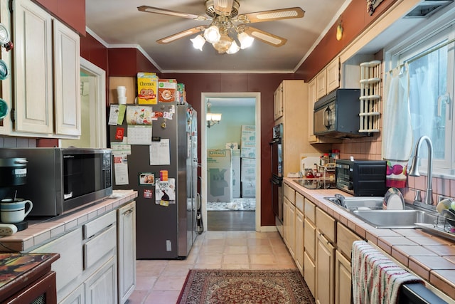 1479 Devonhurst Dr, Columbus, OH 43232 - kitchen featuring black appliances, tile counters, a ceiling fan, and ornamental molding