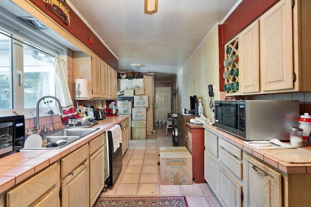1479 Devonhurst Dr, Columbus, OH 43232 - kitchen with stainless steel microwave, tile countertops, light tile patterned floors, black dishwasher, and light brown cabinets