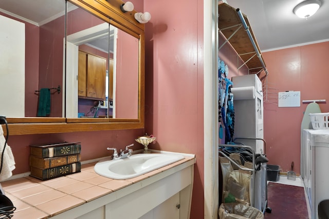 1479 Devonhurst Dr, Columbus, OH 43232 - bathroom featuring washing machine and clothes dryer, vanity, and ornamental molding