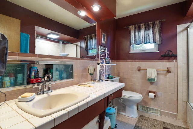 1479 Devonhurst Dr, Columbus, OH 43232 - bathroom featuring a shower with door, tile patterned floors, vanity, tile walls, and wainscoting