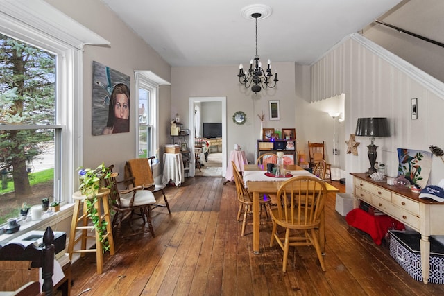 dining area with hardwood / wood-style flooring and a notable chandelier