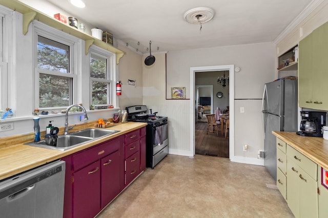 kitchen featuring stainless steel appliances, open shelves, red cabinetry, a sink, and baseboards