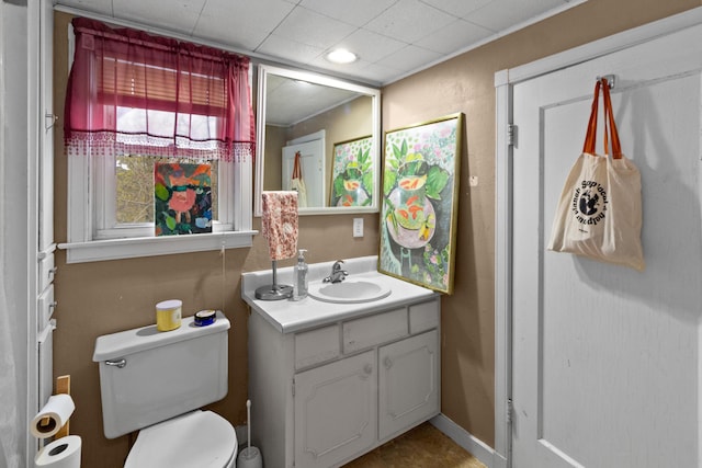 half bathroom featuring vanity and toilet