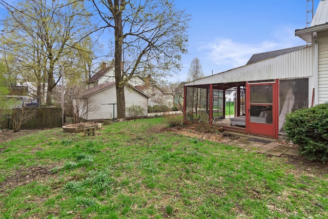 view of yard featuring a sunroom and fence