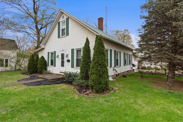 exterior space with a lawn and a chimney