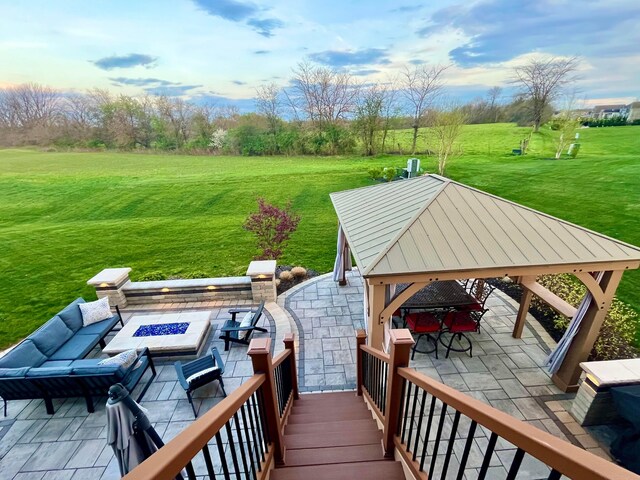 wooden terrace with a gazebo, a yard, an outdoor living space with a fire pit, and a patio