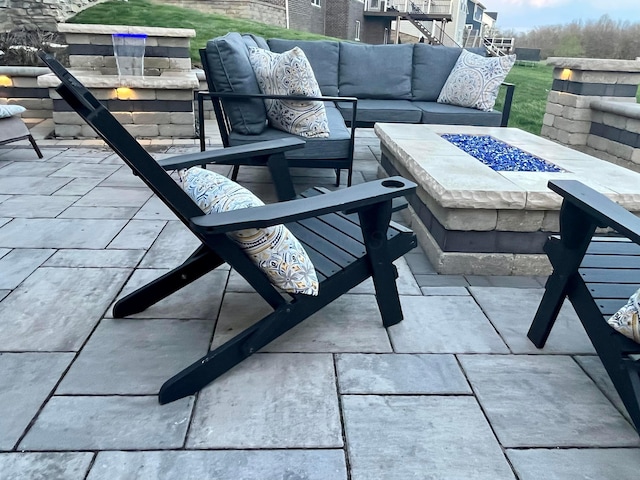 view of patio featuring an outdoor living space with a fire pit