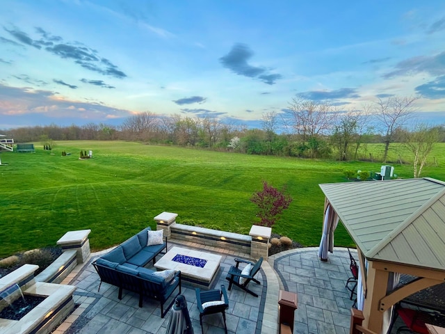 view of patio featuring a rural view and an outdoor living space with a fire pit