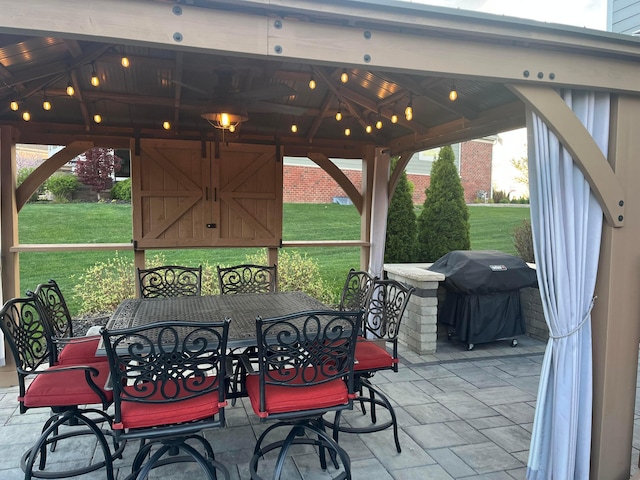 view of patio featuring a gazebo, outdoor dining space, and a grill