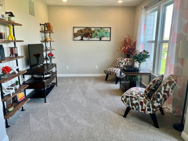 sitting room with plenty of natural light, recessed lighting, visible vents, and carpet