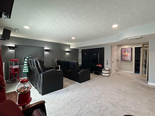 cinema room featuring recessed lighting, a textured ceiling, and light colored carpet