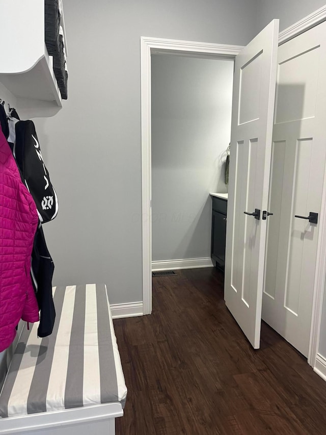 mudroom with baseboards, wood finished floors, and visible vents