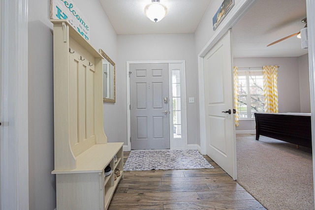 mudroom featuring ceiling fan, baseboards, and dark wood-type flooring
