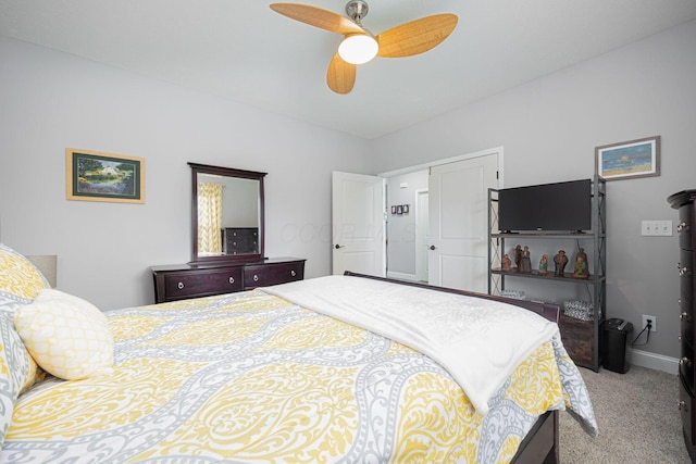 carpeted bedroom featuring baseboards and a ceiling fan