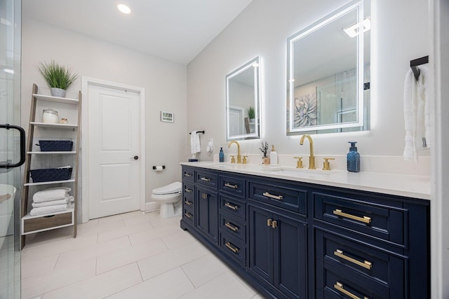 full bathroom featuring a shower with door, a sink, double vanity, and toilet