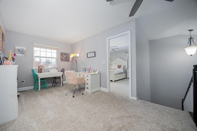 carpeted office with ceiling fan, baseboards, and vaulted ceiling