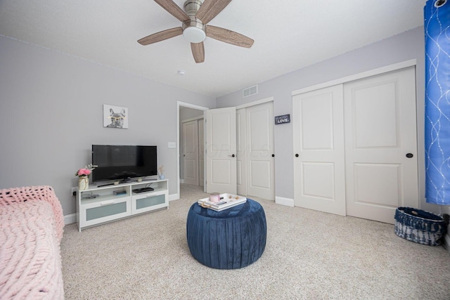 living area with ceiling fan, baseboards, carpet flooring, and visible vents