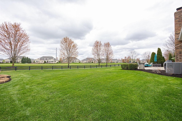 view of yard with a residential view and fence