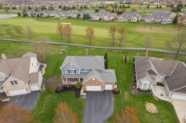 aerial view with a residential view and view of golf course
