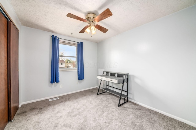 bedroom featuring visible vents, carpet floors, a closet, baseboards, and a textured ceiling