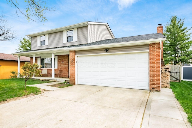 traditional-style house with driveway, a porch, fence, brick siding, and an attached garage