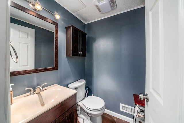 half bath with toilet, vanity, wood finished floors, and visible vents