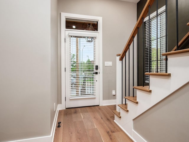 496 W 1st Ave, Columbus, OH 43201 - entryway with stairs, wood finished floors, and baseboards