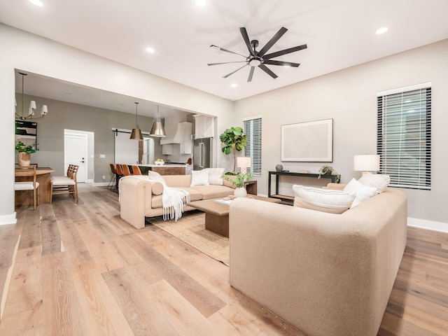 496 W 1st Ave, Columbus, OH 43201 - living area featuring ceiling fan, baseboards, light wood-type flooring, recessed lighting, and a chandelier