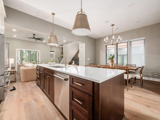 496 W 1st Ave, Columbus, OH 43201 - kitchen with dishwasher, open floor plan, light wood-type flooring, a sink, and recessed lighting