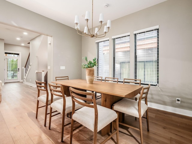 496 W 1st Ave, Columbus, OH 43201 - dining area with light wood finished floors, baseboards, a chandelier, stairs, and recessed lighting