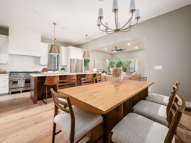 496 W 1st Ave, Columbus, OH 43201 - dining room with a chandelier, light wood-style floors, and recessed lighting