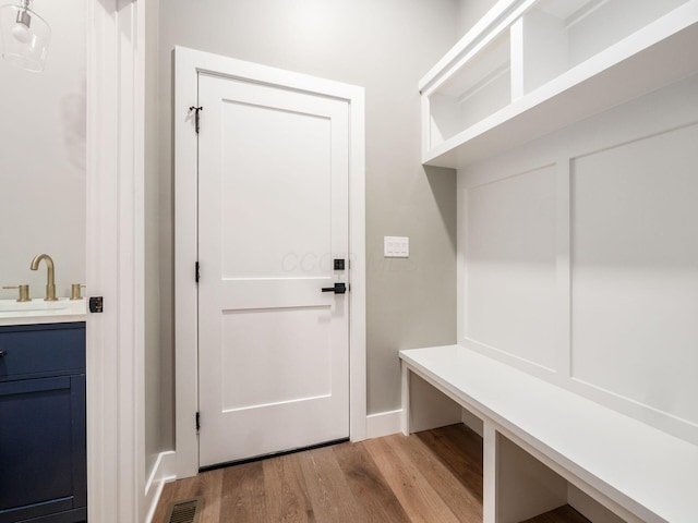 496 W 1st Ave, Columbus, OH 43201 - mudroom featuring a sink, wood finished floors, and baseboards