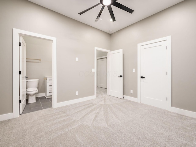 496 W 1st Ave, Columbus, OH 43201 - unfurnished bedroom with carpet floors, baseboards, connected bathroom, tile patterned flooring, and ceiling fan