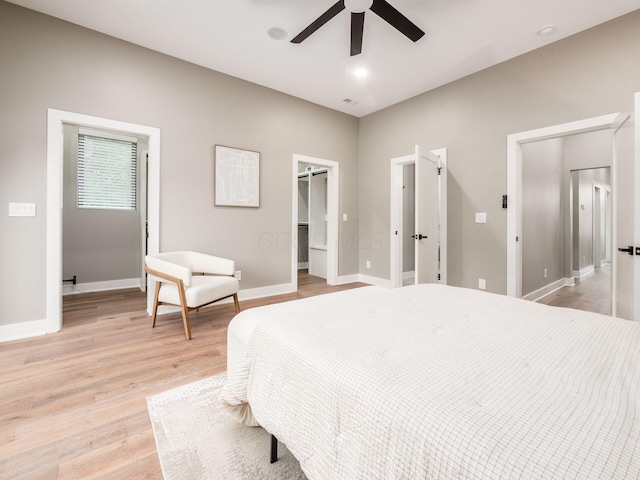 496 W 1st Ave, Columbus, OH 43201 - bedroom with light wood-style floors, a spacious closet, baseboards, and ceiling fan