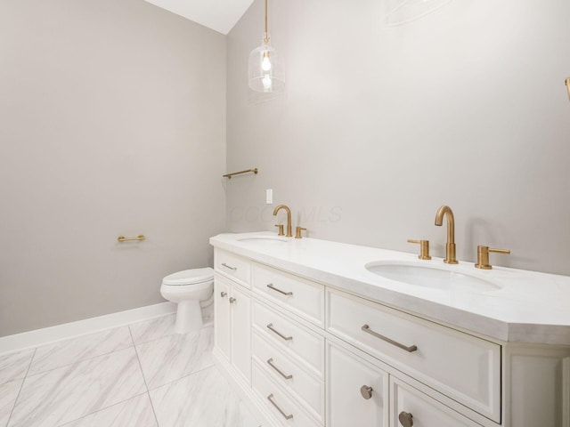 496 W 1st Ave, Columbus, OH 43201 - bathroom featuring toilet, marble finish flooring, baseboards, and double vanity