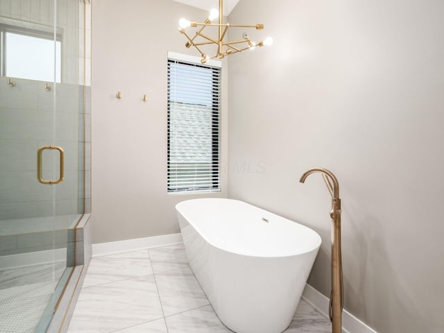 496 W 1st Ave, Columbus, OH 43201 - full bathroom with marble finish flooring, a chandelier, a shower stall, a soaking tub, and baseboards