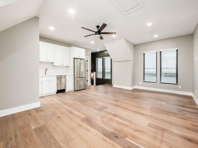 496 W 1st Ave, Columbus, OH 43201 - unfurnished living room featuring ceiling fan, light wood-style floors, recessed lighting, baseboards, and a sink