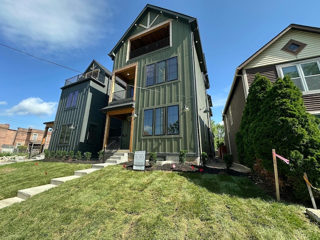 496 W 1st Ave, Columbus, OH 43201 - rear view of house featuring a balcony, board and batten siding, and a yard