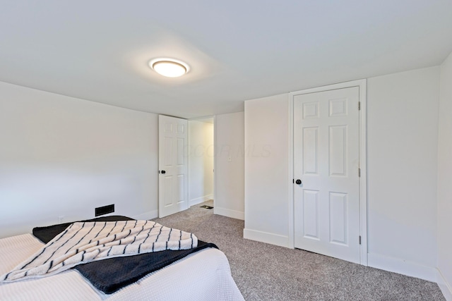 bedroom with baseboards and light carpet