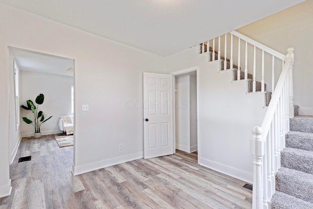 interior space with baseboards and wood finished floors