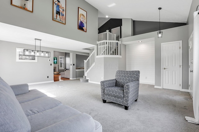 carpeted living area featuring high vaulted ceiling, baseboards, and stairway