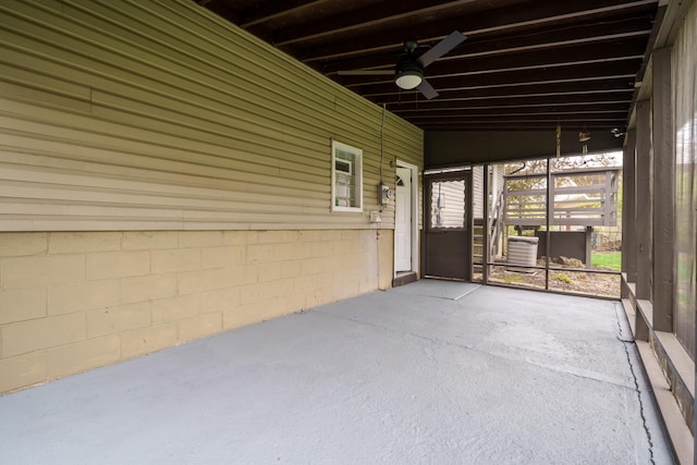 unfurnished sunroom with a ceiling fan