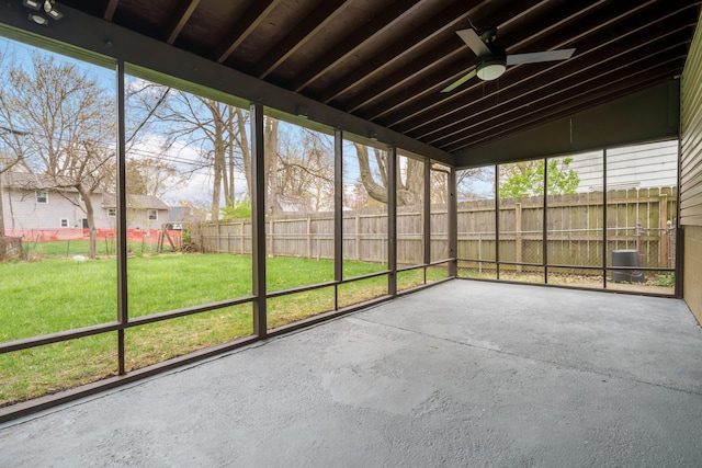unfurnished sunroom featuring ceiling fan