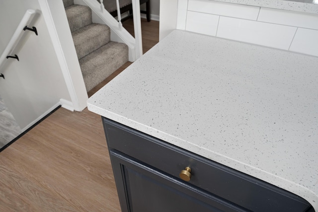 room details featuring baseboards and wood finished floors