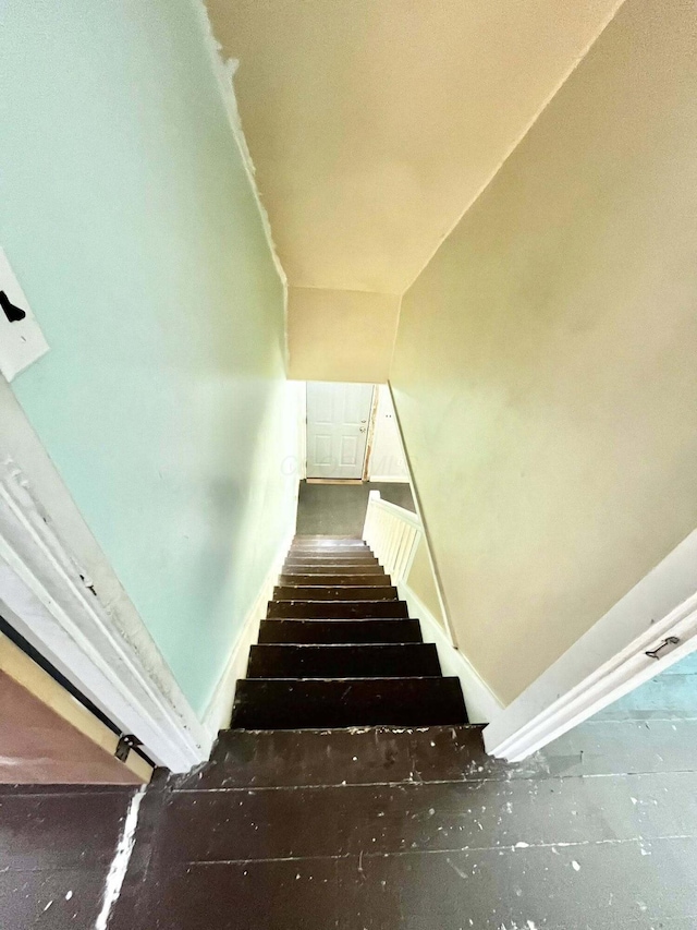 stairway featuring baseboards