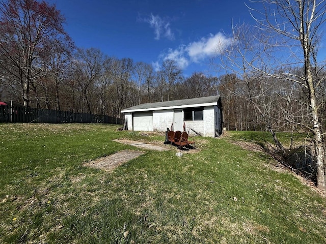 exterior space with an outdoor structure and fence