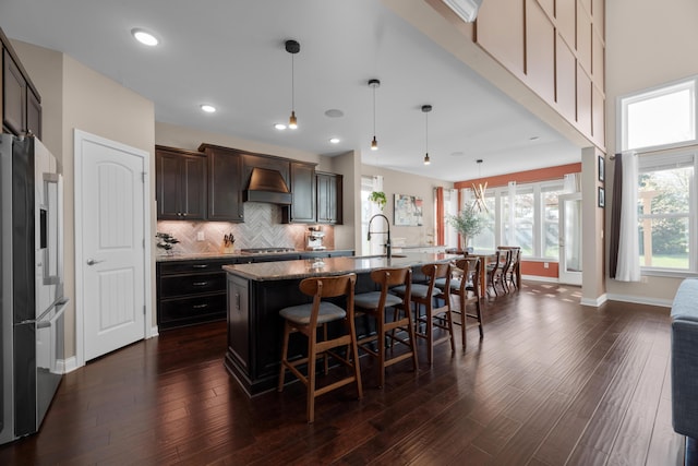 816 Kelburn Ln, Pickerington, OH 43147 - kitchen with stainless steel gas stovetop, wall chimney range hood, a sink, high end refrigerator, and baseboards